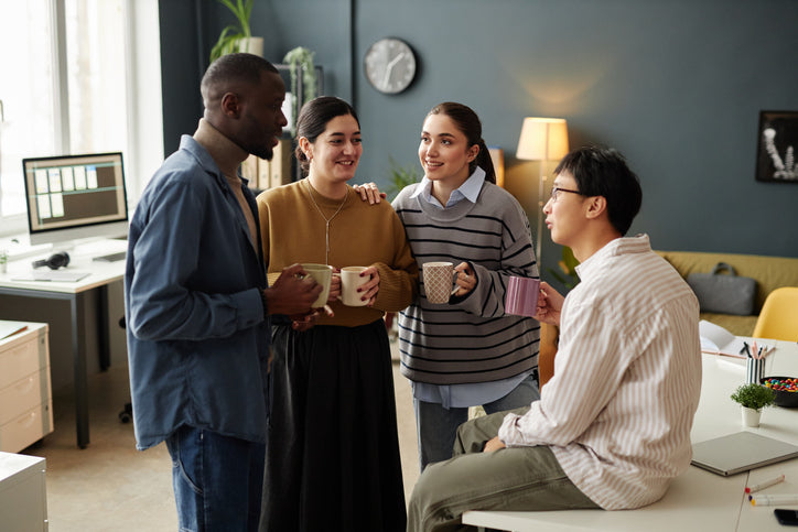 Group of friends gathered in a house enjoying cups of coffee made with barista quality coffee machine
